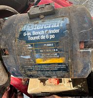 Close-up photo of the side label on the Mastercraft bench grinder showing model number and technical specifications.