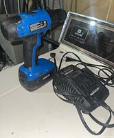Mastercraft 18V cordless drill with battery attached and charger on a flat surface.