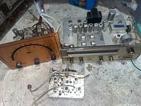 Copper-faced stereo VU meter panel, FM tuner chassis and small IF board on workbench