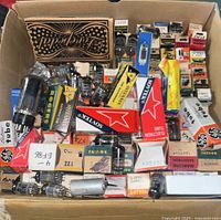 Box with an assortment of vintage radio vacuum tubes including Sovtek, GE, Rogers and others in original packaging and loose tubes