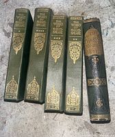 Spines of four Shakespeare books and one Pilgrim's Progress book with gold embossed titles on green covers.