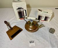 Lot with Bodum Bistro Coffee Press, Bistro-Duo coffee cups in boxes, copper tea pot, coffee ground whisk and brush on a white tablecloth.