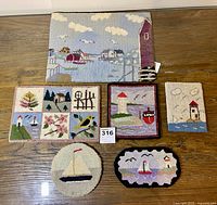 Overview of six nautical-themed hooked trivets on wooden surface