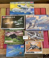 Full overview of all seven individual model kits displayed on a wooden surface.