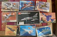 Overview of all nine model kits showing box art and titles of aircraft models including A-10 Thunderbolt II, F-7EB, F-4E Phantom, F/A-18 Hornet, Mirage III-R, F-7MG, SU-22 Fitter, F-14A Tomcat, F-15A Eagle