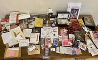 Wide angle shot showing all items on table, including cards, DVDs, rope, magic notes, and boxes