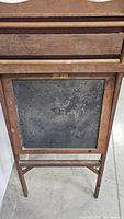 Frontal view of the easel showing chalkboard surface and wooden frame.