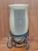 Front view of the Lasko Designer Series space heater showing its crackled ceramic body and black mesh grill.