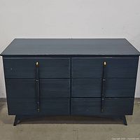 Front view of blue 6-drawer dresser with handles and short legs