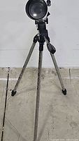 Full view of the telescope on tripod showing leg placement and front lens.