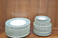 Stacks of dinner, salad, dessert, and bread plates showing side profile