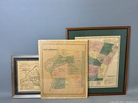 Three vintage framed maps displayed together showing Boston, East Hartford, and Simsbury maps with various frames.