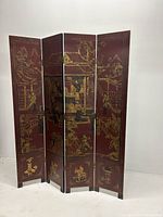 Full view of the four-panel wood room divider with Asian-themed painted scenes in gold on a reddish-brown background.
