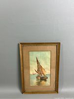 Full view of the framed watercolor painting depicting a sailboat in a harbor scene.