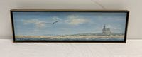Full view of the framed oil painting showing the lighthouse coastal scene with blue sky and seagull.