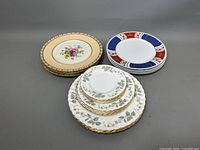 Overview photo showing multiple stacked plates in three distinct groups by design and brand.