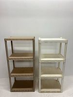 Front view showing both beige and white plastic shelving units side by side against a white wall.