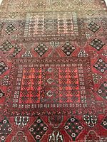 Close-up of the rug showing the detailed geometric patterns and colors.