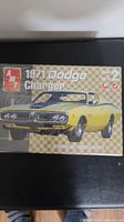Front of sealed AMT 1/25 scale 1971 Dodge Charger plastic model kit box with yellow car artwork.