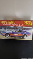 Box front with artwork showing blue Mustang funny car 'Digger' model with Sponsor decals and Jo-Han branding