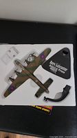 Top view of Avro Lancaster model with stand and paperwork in foam insert