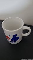 White ceramic coffee mug with Montreal Expos logo visible on the side and square handle.