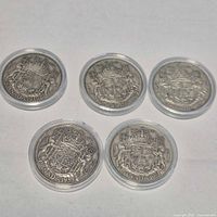 All five Canadian silver 50-cent coins in holders