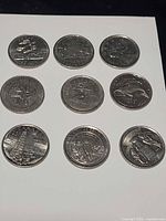 Nine commemorative quarters laid out 3×3 showing full reverse designs