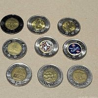 All nine coins laid out in 3×3 grid