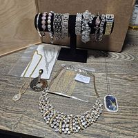 Group showing bracelets on stand and assorted necklaces and ear clips