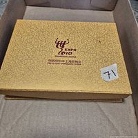gold brocade outer box with Expo 2010 logo