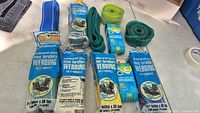Group shot showing all sealed and loose rolls of lawn furniture webbing