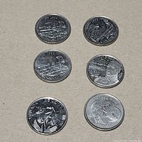 Front view of six commemorative quarters showing reverse designs