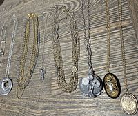 All eight necklaces laid flat showing pendants and chain styles