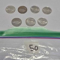 Seven 1967 silver quarters in bag marked 50