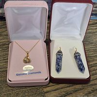 Both jewelry boxes showing necklace and earrings