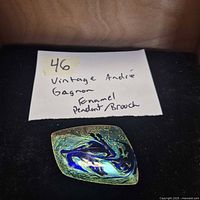 Front view showing abstract blue/green/gold enamel design