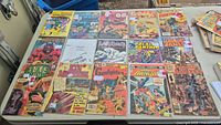 Overall lot of 16 comics laid out on table