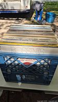 Blue milk crate filled with assorted LPs, Rossini album at front