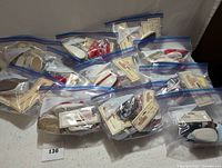 Multiple resealable plastic bags filled with doll shoes, each pair with original tags labeled "Shoepanies Doll Shoes."