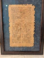 Framed piece with Mayan calendar glyphs on textured parchment mounted on blue background