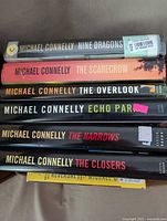 Stack of six Michael Connelly hardcover books showing the spines with titles and author name clearly visible.
