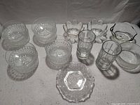 Overview of all glass items including matching bowls, drinking glasses, additional bowls, and decorative dish