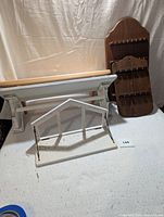 Five wooden kitchen storage items consisting of two spoon racks and three shelves arranged on a white and black background.