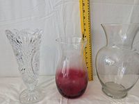 Three vases shown side by side with measuring tape indicating height.