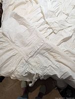 Photo showing detailed hand-stitched pleating and smocking on fabric of vintage nightgown and robe