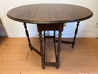 Front view of table with both drop leaves extended
