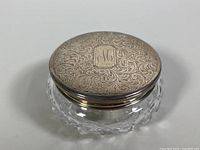 Assembled jar with lid on showing engraved silver lid and crystal base.
