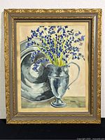 Framed watercolor painting of blue flowers in silver vase with silver plate background.