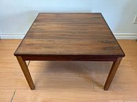 Full front-facing view of square coffee table on wood floor